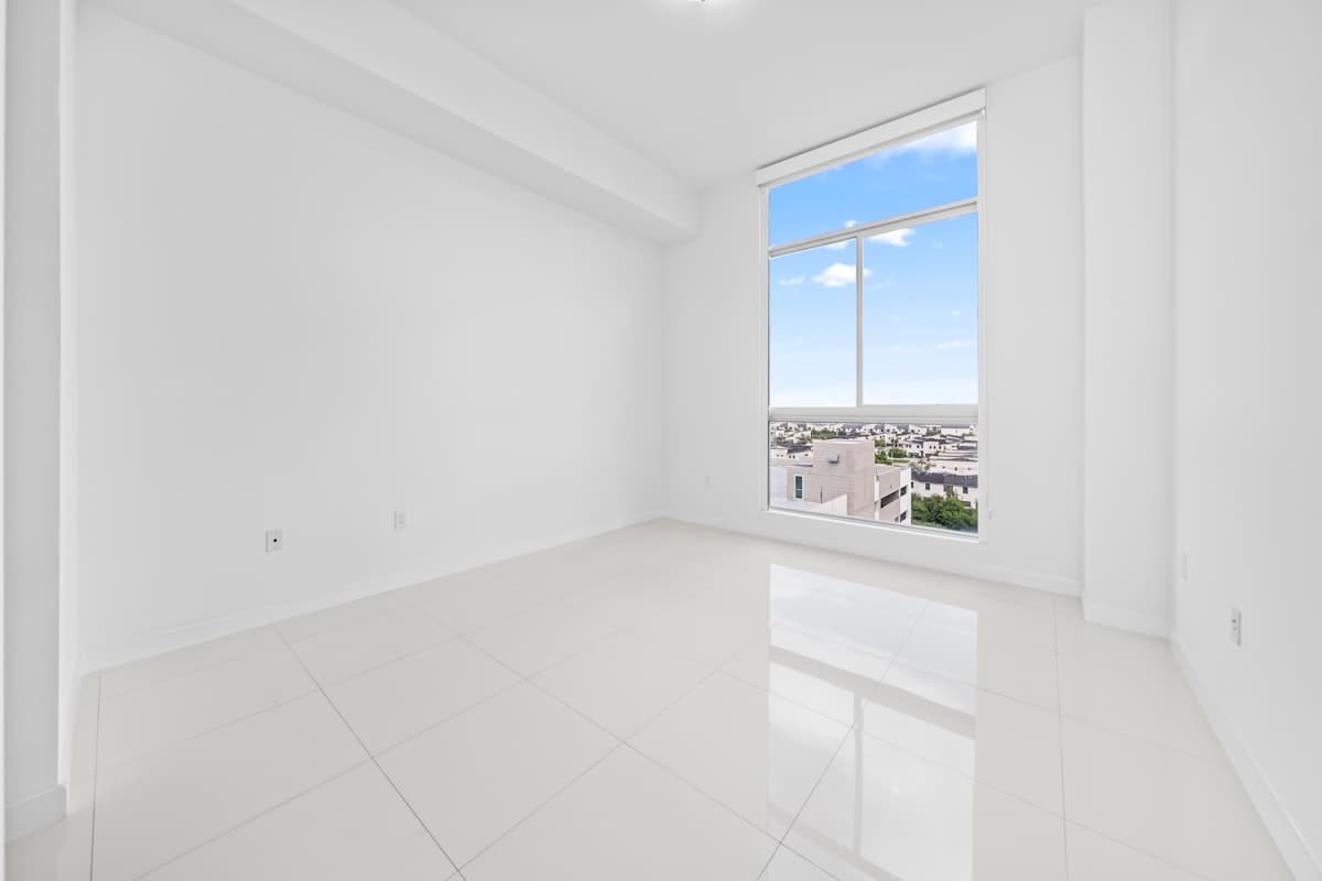 Bright empty room with large windows ready for new tenants