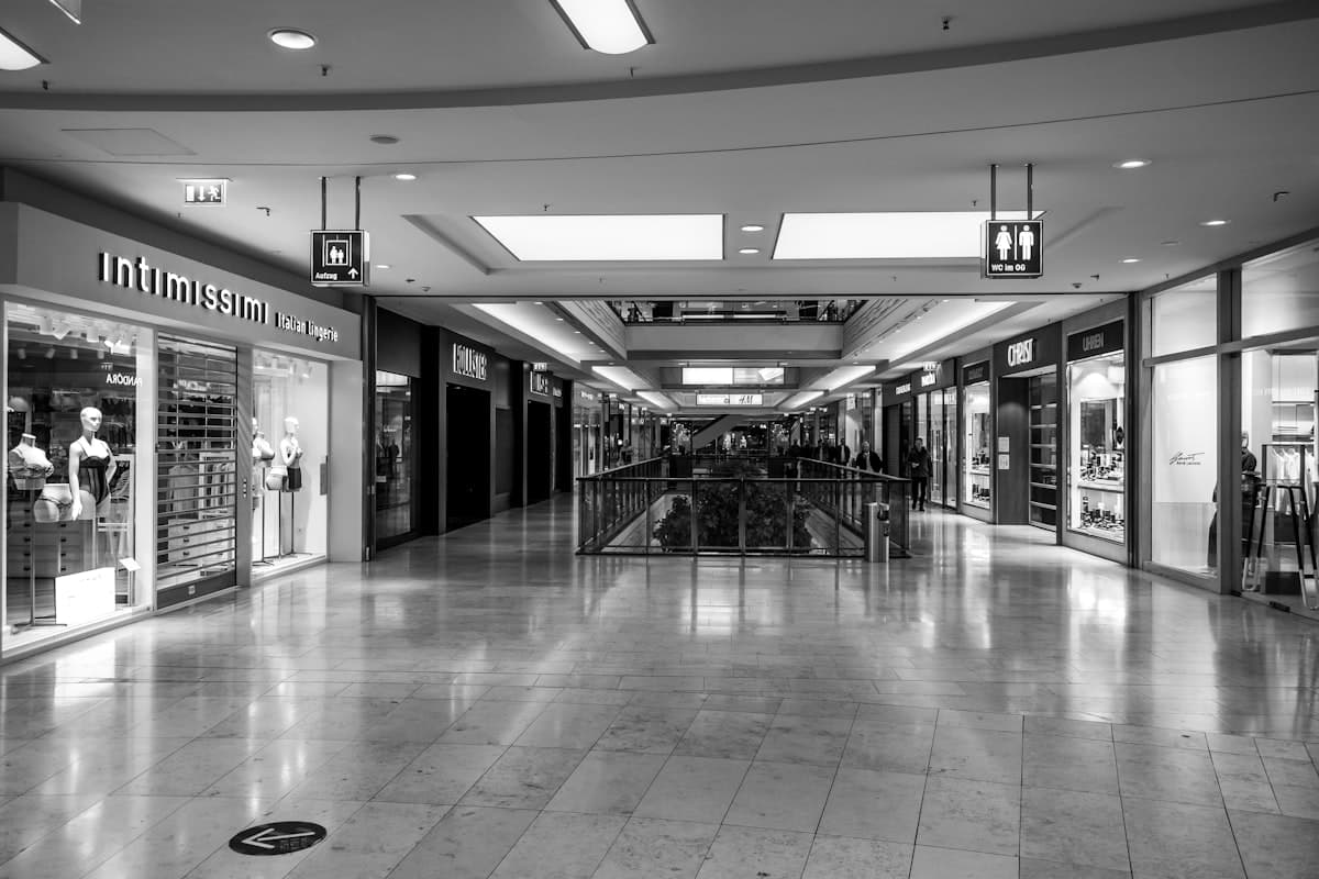 Empty shopping mall corridor with spotless storefronts